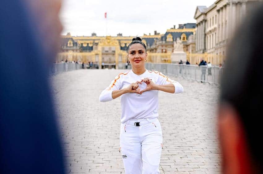 Salma Hayek carries Olympic torch at official relay in Versailles