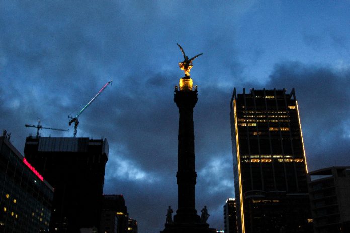 Mexico City cityscape view at night with cloudy sky