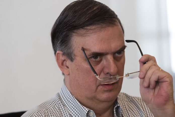 Marcelo Ebrard looks over his glasses