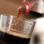 A glass with Coca Cola poured into it