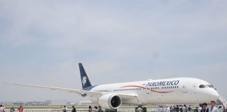 Aeromexico plane on display at an event where visitors are walking around a large tarmac near the plane