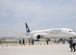 Aeromexico plane on display at an event where visitors are walking around a large tarmac near the plane