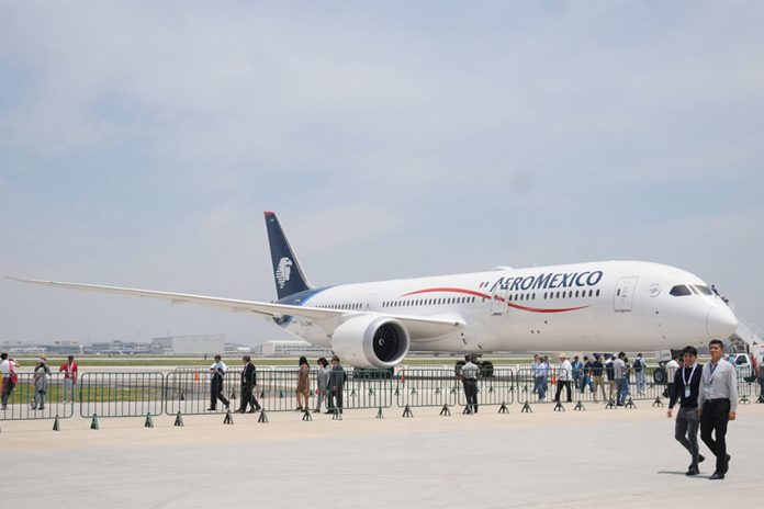 Aeromexico plane on display at an event where visitors are walking around a large tarmac near the plane