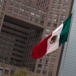 A Mexican flag flying in Mexico City's business district