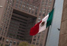 A Mexican flag flying in Mexico City's business district