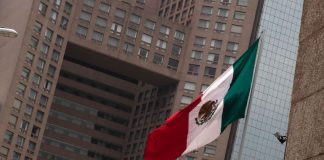 A Mexican flag flying in Mexico City's business district