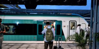 A passenger waits to board the Maya Train