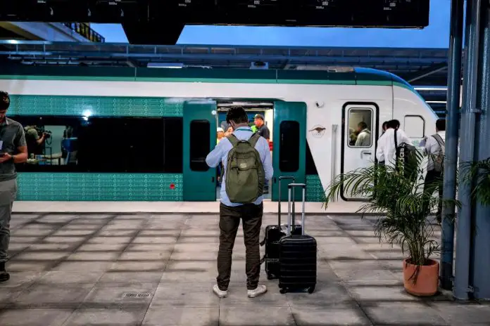 A passenger waits to board the Maya Train