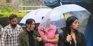 People carrying umbrellas in the rain