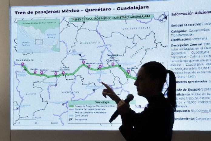 President-elect Claudia Sheinbaum pointing to a presentation of a new passenger train route