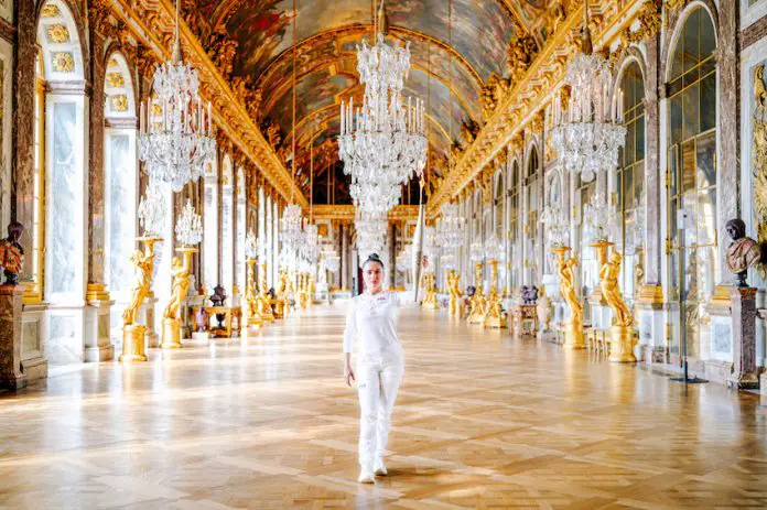 The Mexican actress Salma Hayek Pinault holding the 2024 Olympic torch in the Palace of Versailles