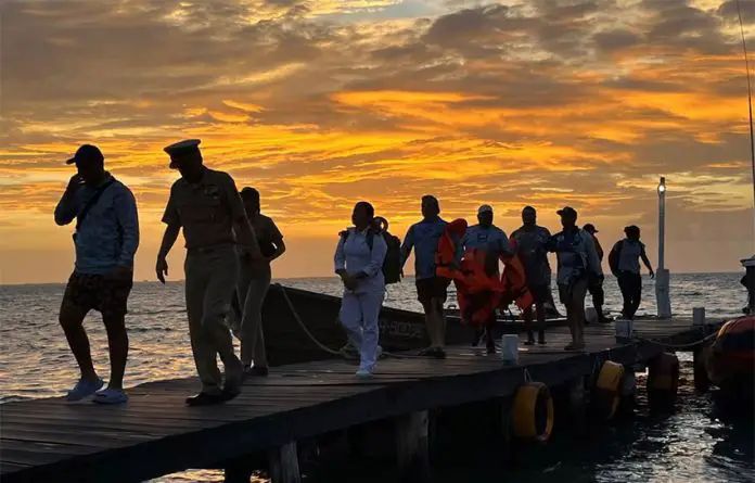 Six members of a fishing charter arrive at a dock in Isla Mujeres, Quintana Roo after being rescued.