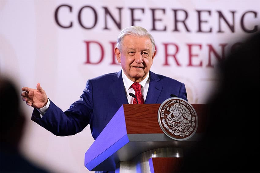 AMLO stands speaking at a podium