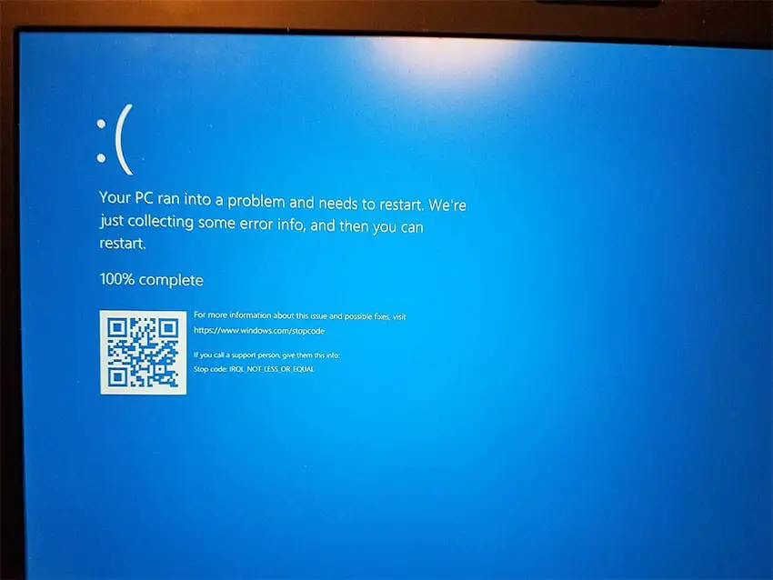 A blue computer error screen displays a frowny-face