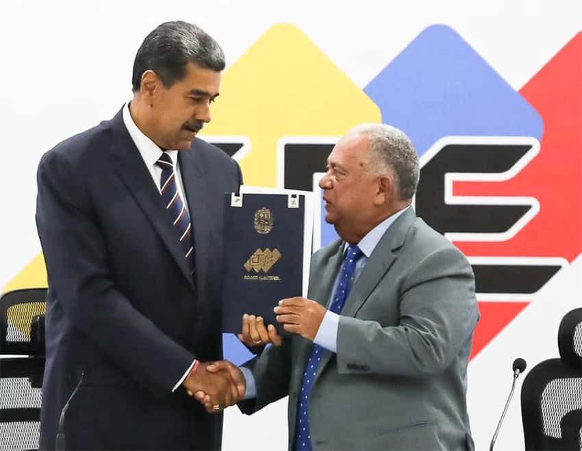 Electoral director and former Venezuelan president Elvis Amoroso hands Maduro the Venezuelan election results. 