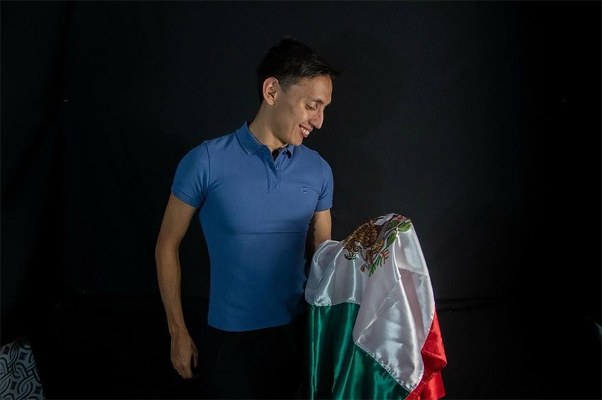 Emiliano Hernández, one of Mexico's flag bearers for the Paris Olympics, holds a Mexican flag