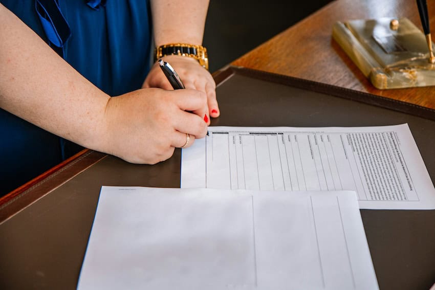 A woman signing a contract