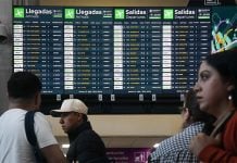 Airport screens showing dozens of canceled and delayed flights.