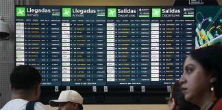 Airport screens showing dozens of canceled and delayed flights.