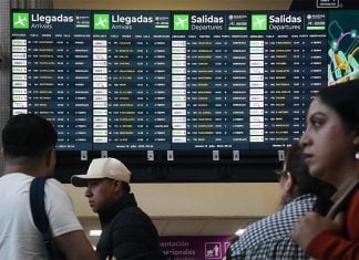 Airport screens showing dozens of canceled and delayed flights.