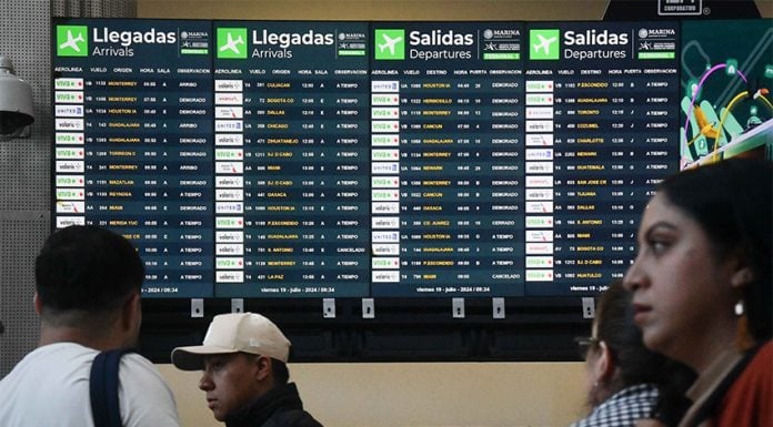 Airport screens showing dozens of canceled and delayed flights.