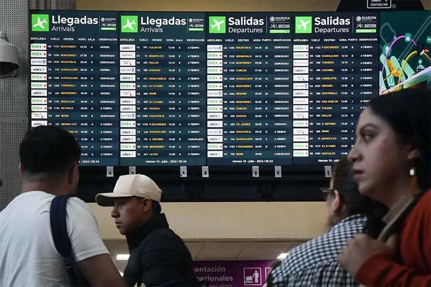 Airport screens showing dozens of canceled and delayed flights.