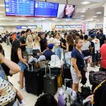 Passengers wait in the crowded Cancún airport during the global Microsoft IT meltdown in Mexico.
