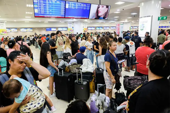 Passengers wait in the crowded Cancún airport during the global Microsoft IT meltdown in Mexico.