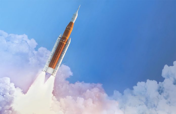 A rocket blasts through clouds and into the blue sky, representing Querétaro airport's goal of becoming an aerospace port