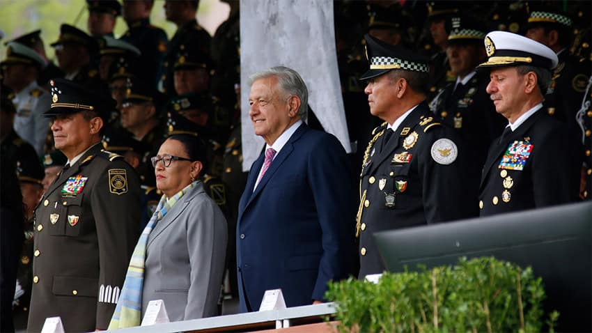 Security Minister Rosa Icela Rodríguez accompanies President López Obrador at a military event.