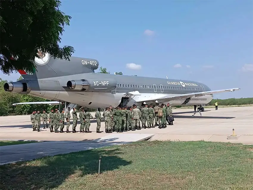 Mexican soldiers unload from an airplane in Culiacán after the arrest of El Mayo Zambada in Texas.