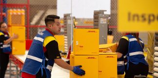 DHL worker in Mexico moving boxes on an conveyor belt in a warehouse