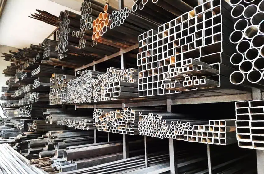 Steel rods and tubes for building construction sitting on shelving, on display for sale.