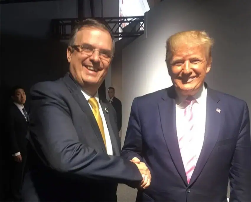 Trump and Ebrard shake hands in a backstage area