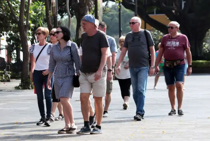 International tourists wander a historic plaza in Cuernavaca, Morelos, Mexico.