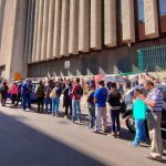 People waiting on line outside a SAT building, an example of Mexican bureaucracy