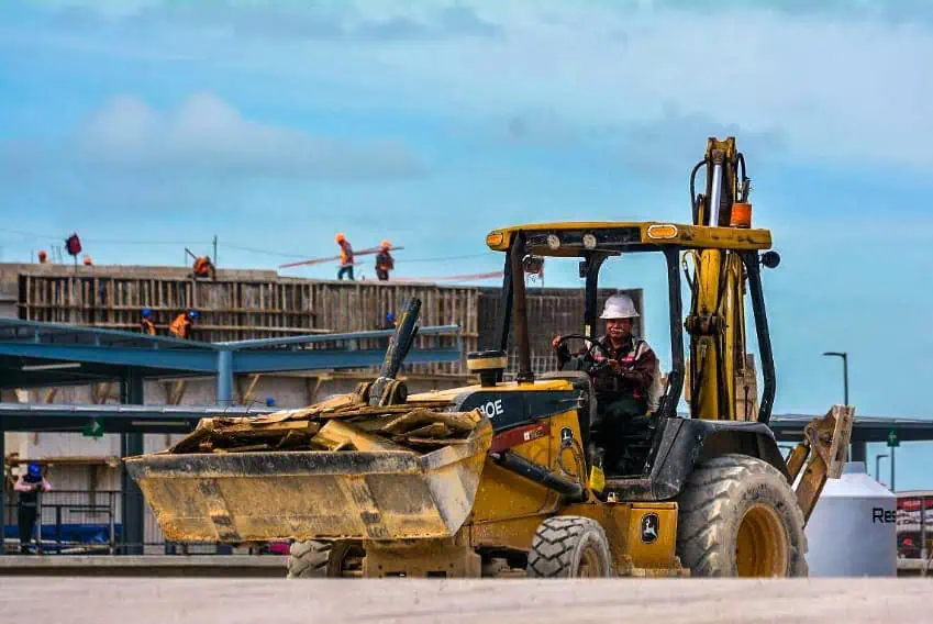 A backhoe at a construction site for the Maya Train