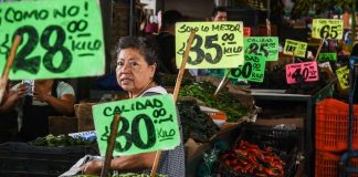 Price signs in a produce market, showing inflation in Mexico