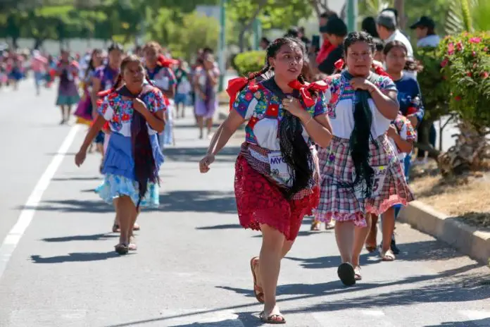 Women of all ages wearing huipiles and other traditional garments run in the Coapan, Puebla, Tortilla Race.