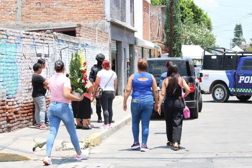 People outside the murdered reporter's home in Celaya, Guanajuato