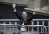 Claudia Shienbaum waves her hands in the air to crowds in Mexico City's Zocalo behind metal security barriers