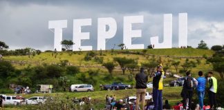 Giant Hollywood-like landmark sign bearing the name Tepeji stands in the hills.