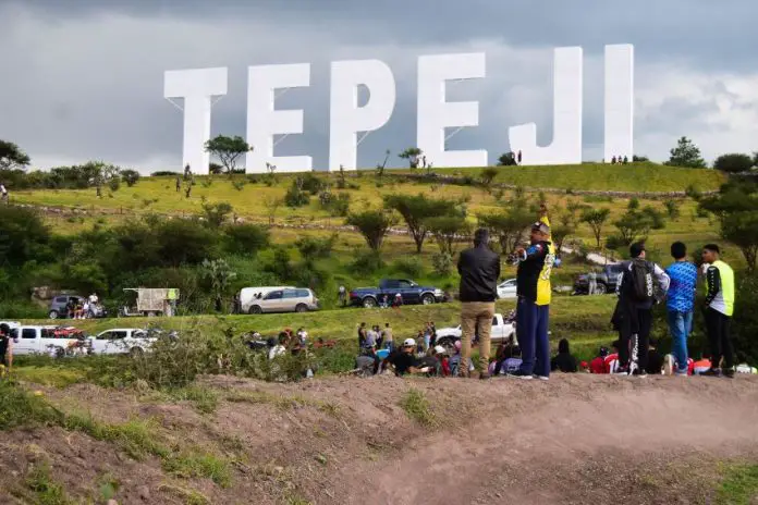 Giant Hollywood-like landmark sign bearing the name Tepeji stands in the hills.