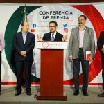 Morena party leader Ignacio Mier at a podium announcing changes to Mexico's proposed judicial reform, shortly before a court workers strike.