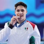 Diver Osmar Olvera bites his silver medal. What do Mexican Olympic medalists win when they come home?