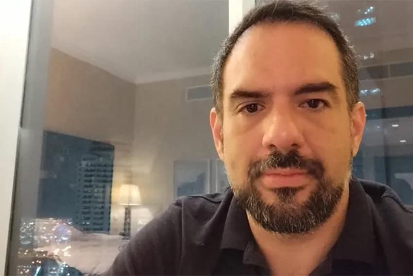 Manuel Guerrero poses for a photo in an apartment