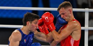 Boxer Marco Verde taking a punch at boxer Lewis Richardson at the 2024 Olympics semifinals in the 67kg division