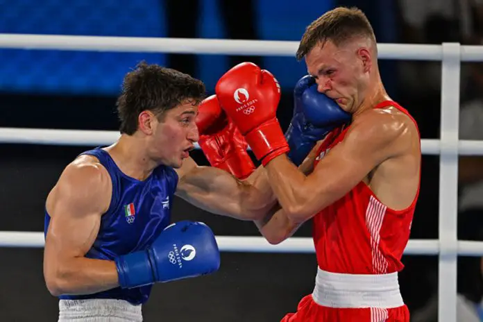 Boxer Marco Verde taking a punch at boxer Lewis Richardson at the 2024 Olympics semifinals in the 67kg division