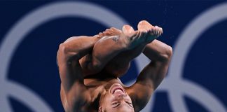 Mexican diver Osmar Olvera caught upside down in mid-air during a dive at the semifinals of the 2024 Olympics 3-meter springboard diving event