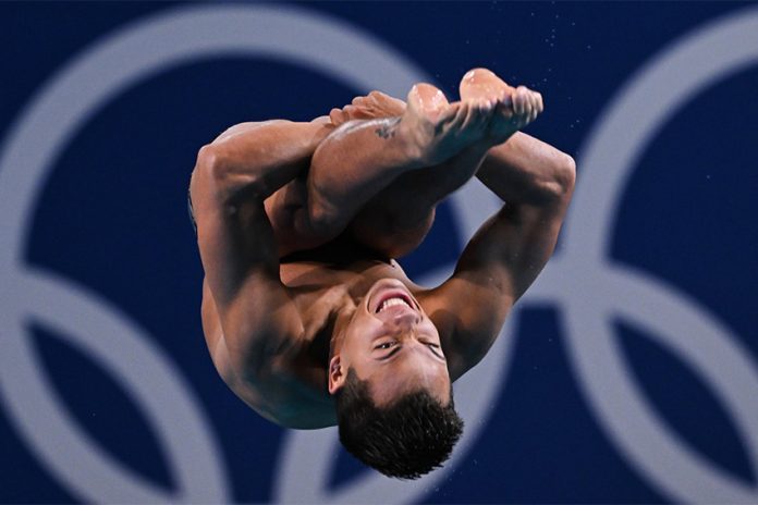 Mexican diver Osmar Olvera caught upside down in mid-air during a dive at the semifinals of the 2024 Olympics 3-meter springboard diving event